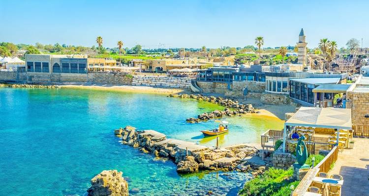 Coastal archaeological site with clear blue waters.
