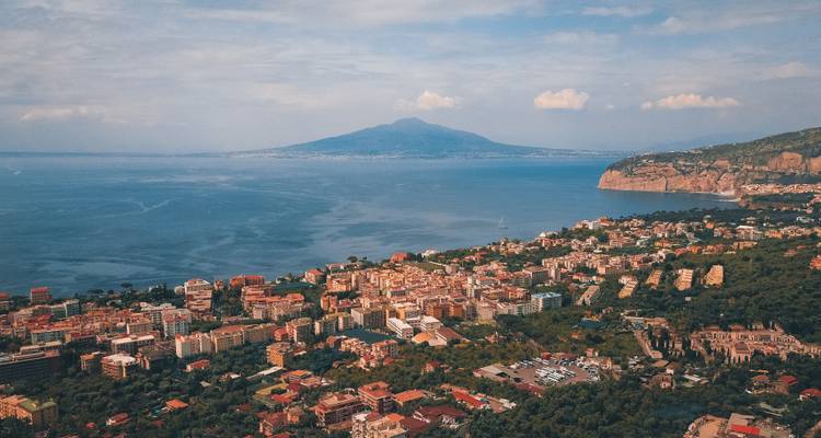 Clifftop view over Sorrento’s coastline with Mount Vesuvius across the bay.
