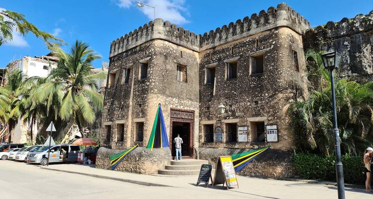 Historic building with Tanzanian decorations and flags.