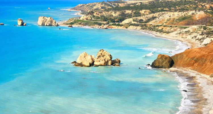 Turquoise Mediterranean waters lap dramatic coastal cliffs and sea stacks