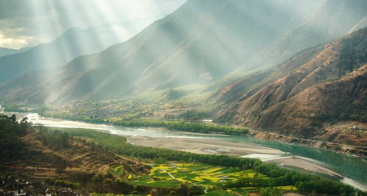 Schilderachtig uitzicht over de Yangtze-riviervallei met zonnestralen die door de wolken breken.