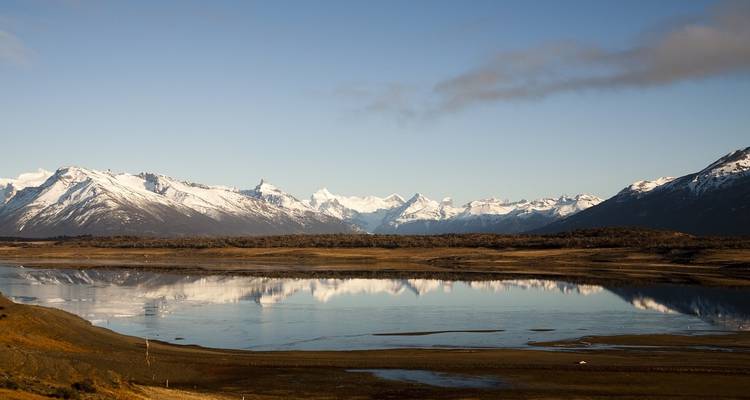 Scenic landscape with mountains reflecting in a calm lake.