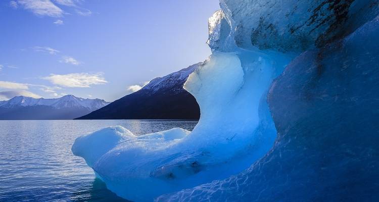 Close-up of a glacier with icy blue formations.