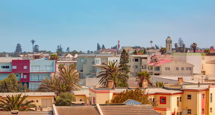 Cityscape with colorful buildings and palm trees.