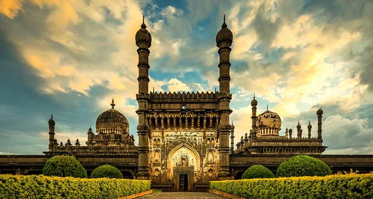 Ancient mausoleum with multiple domes and intricate carvings.