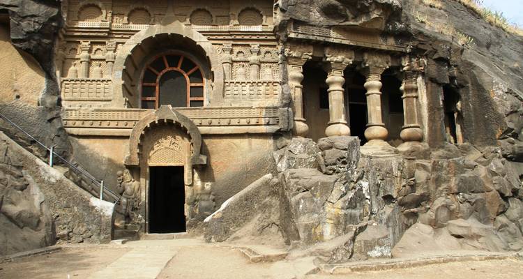 Carved stone facade of an ancient cave temple.