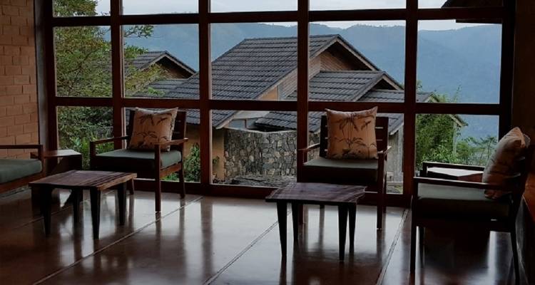 Interior view of a lodge with windows showcasing mountain views.