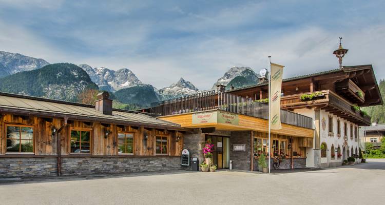 Rustic hotel with scenic mountain background.