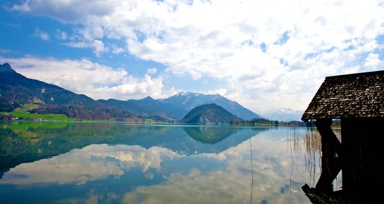 Reflection of mountains and sky in a calm lake.