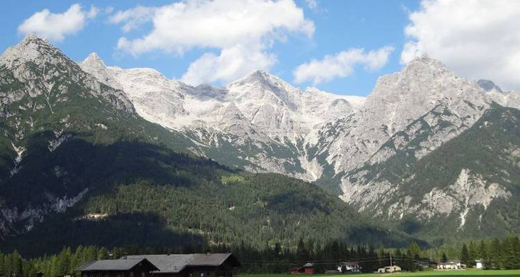 Majestic mountain range with greenery at the base.
