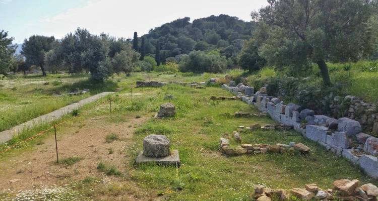 Ruins of ancient structures in a verdant area.