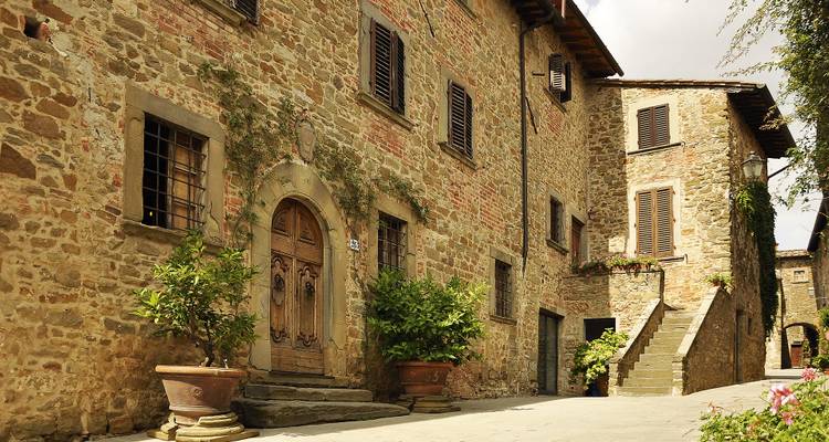 A narrow stone street lined with historic buildings.