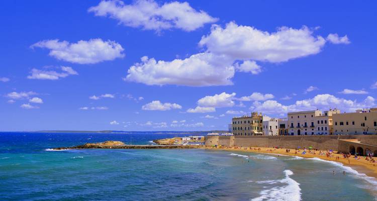 Coastal town with a sandy beach and clear sky.