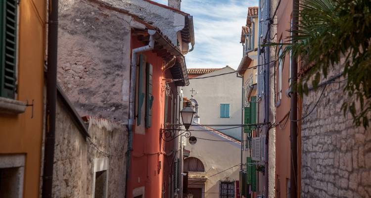 Narrow street in a historic town with colorful buildings.