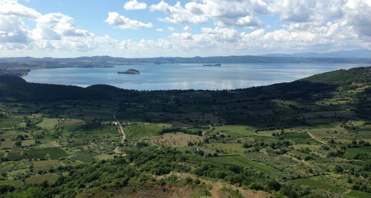 Panoramic view over Lake Bolsena with patchwork farmland and distant islands