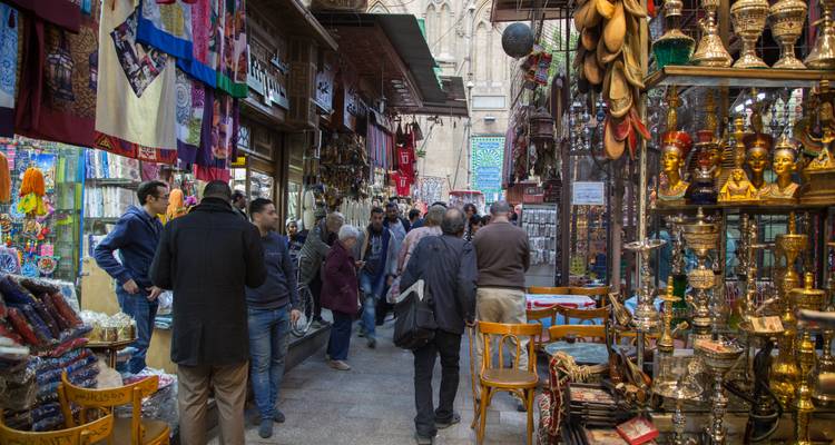 Bustling market street with shops, people, and traditional goods.