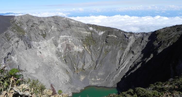 Crater with a turquoise lake viewed from above.