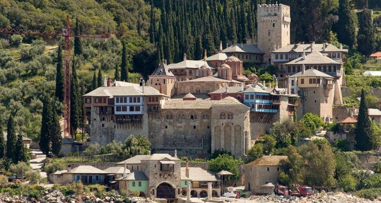 Historic monastery complex nestled in lush greenery.