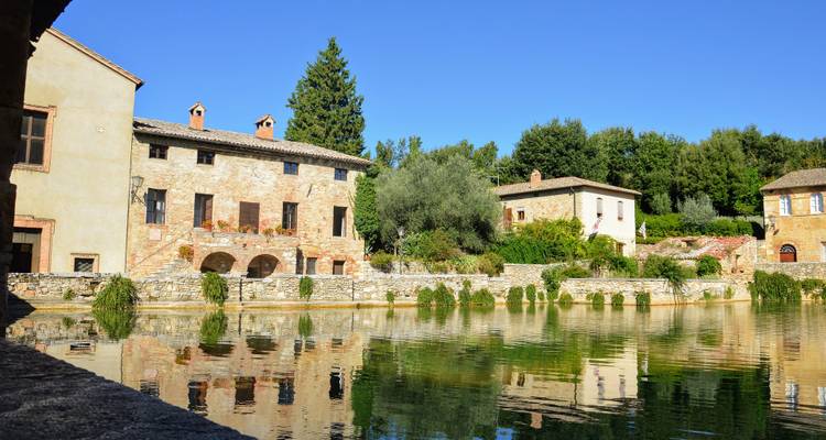 Reflections in a pool with historic buildings around.
