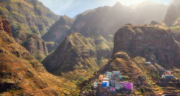 Colorful cliffside village nestled among steep green mountains of Santo Antão
