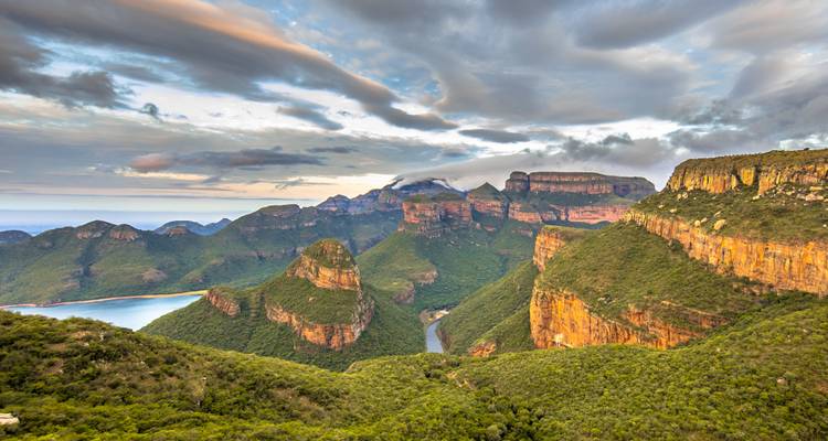 Blyde River Canyon with dramatic cliffs and lush green landscape.