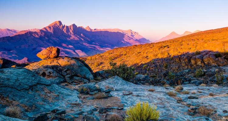 Colorful sunset over rocky mountains and valleys in Oman.