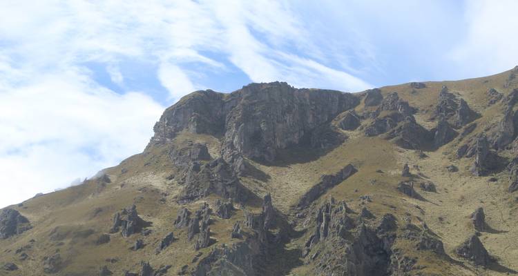 Rocky hill at daytime with cloudy skies.