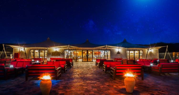 Outdoor dining setup with a starry sky background