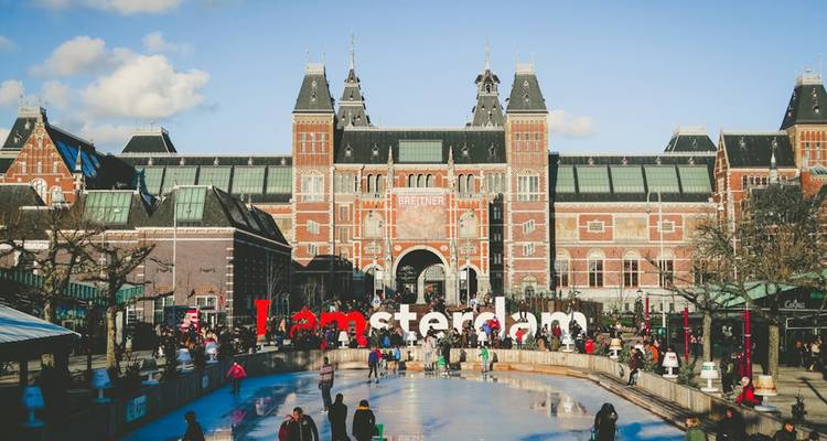 Crowds skate on a winter ice rink in front of Amsterdam’s Rijksmuseum and the iconic ‘Iamsterdam’ sign.