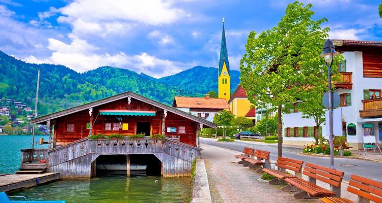 Vibrant lakeside village with mountain backdrop.