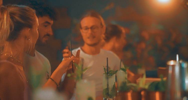 Group enjoying drinks at a bar.