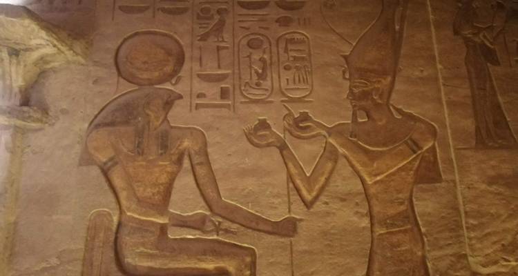Carved figures on ancient Egyptian wall.