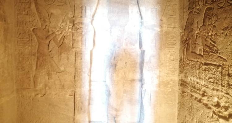 Faded hieroglyphs on a temple wall with lighting issues.