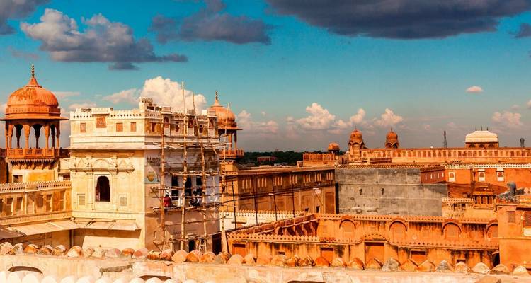 Complexe fortifié en grès rouge sous des cieux vibrants.