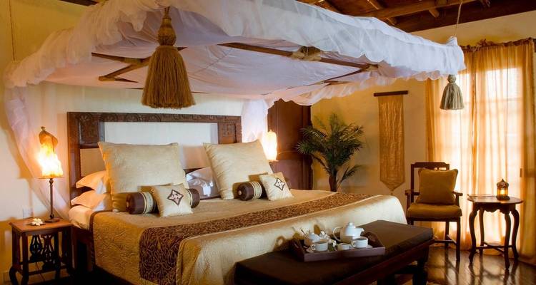 Luxurious bedroom interior with a canopy bed and elegant decor.