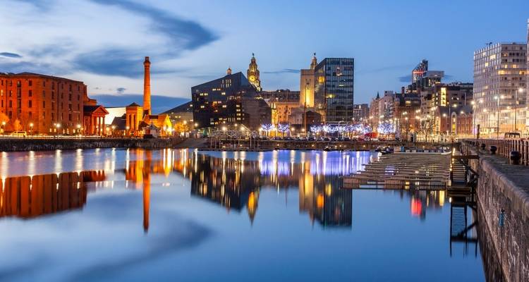 Dramatic night skyline with reflections on the water.