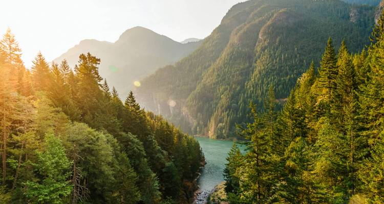 Scenic view of a valley with a river and mountains.