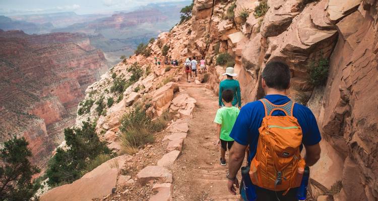 A family hiking along a trail in the Grand Canyon.