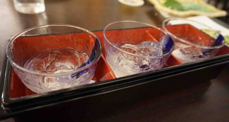 Trio of drinking glasses on a table.