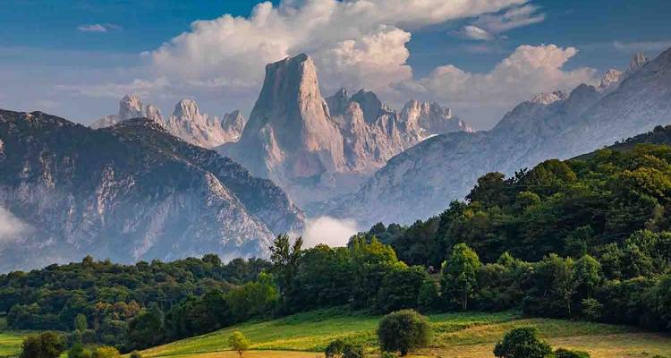 A dramatic mountainous landscape with pointed peaks.