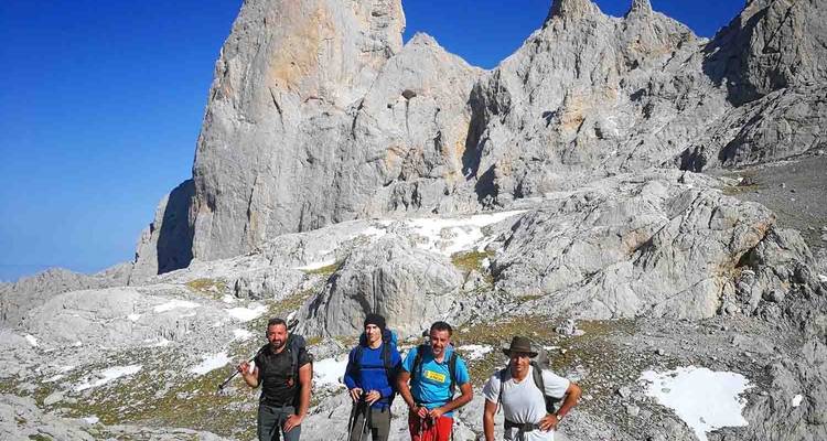 Four hikers in a rugged mountainous area.