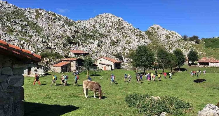 Group of people hiking in a mountainous village.