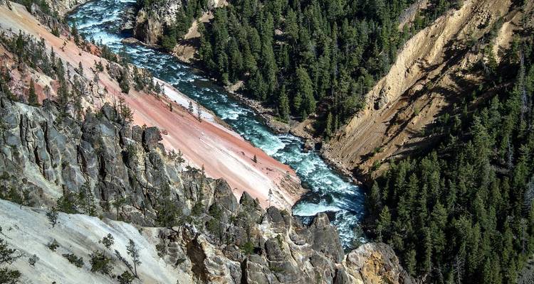 Rugged canyon with a river flowing through it.