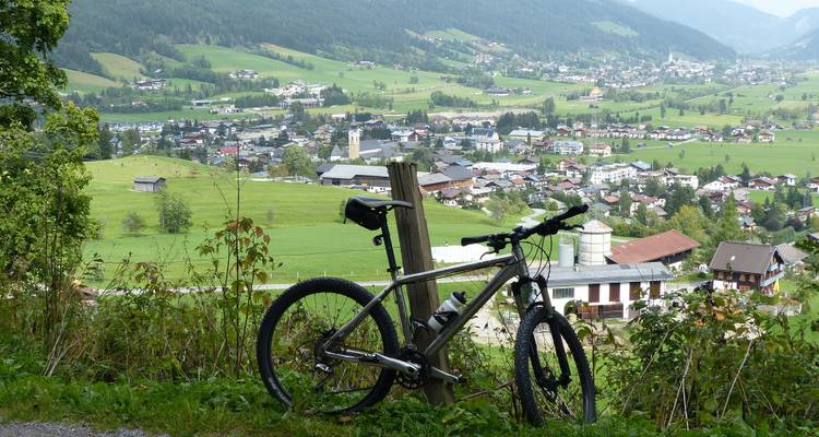 Mountain bike near a small town with a scenic view.