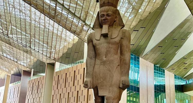 Large statue of a Pharaoh in a modern building.