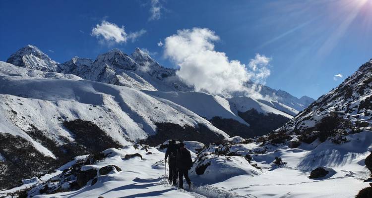 Scenic snowy mountain landscape with a bright blue sky.