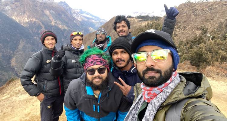 Group of hikers with snowy mountains in the background.