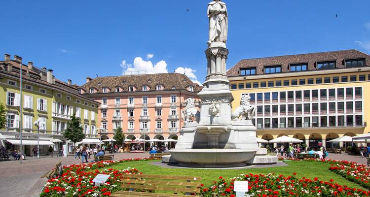 Bozens zentraler Platz mit Menschen und Brunnen.