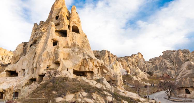 Rock formations with ancient cave dwellings in Cappadocia.