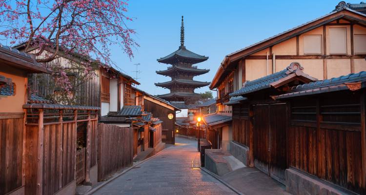Kyoto’s Yasaka Pagoda rises above wooden townhouses on a quiet evening street.